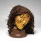 Organic remains. Human mummy. Female head, mummified, with gilded skin, with wig (hair length 0.320 m).
