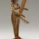 Wooden figure of a woman playing a harp