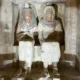 Double seated statue of Neferhotep and his wife Merytre eerily emerge out of the tomb wall.